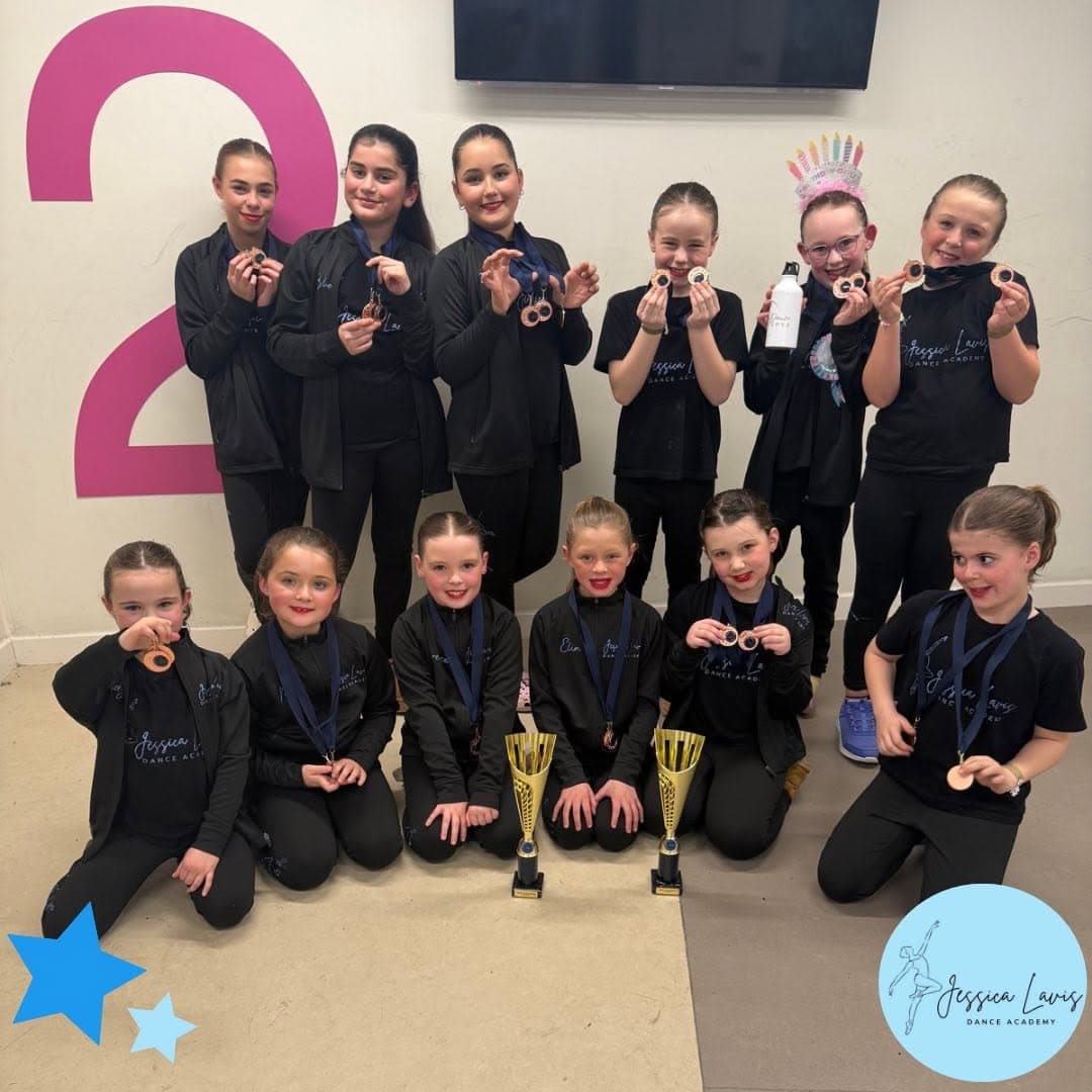 JLDA dancers showing off their bronze medals and two gold trophies