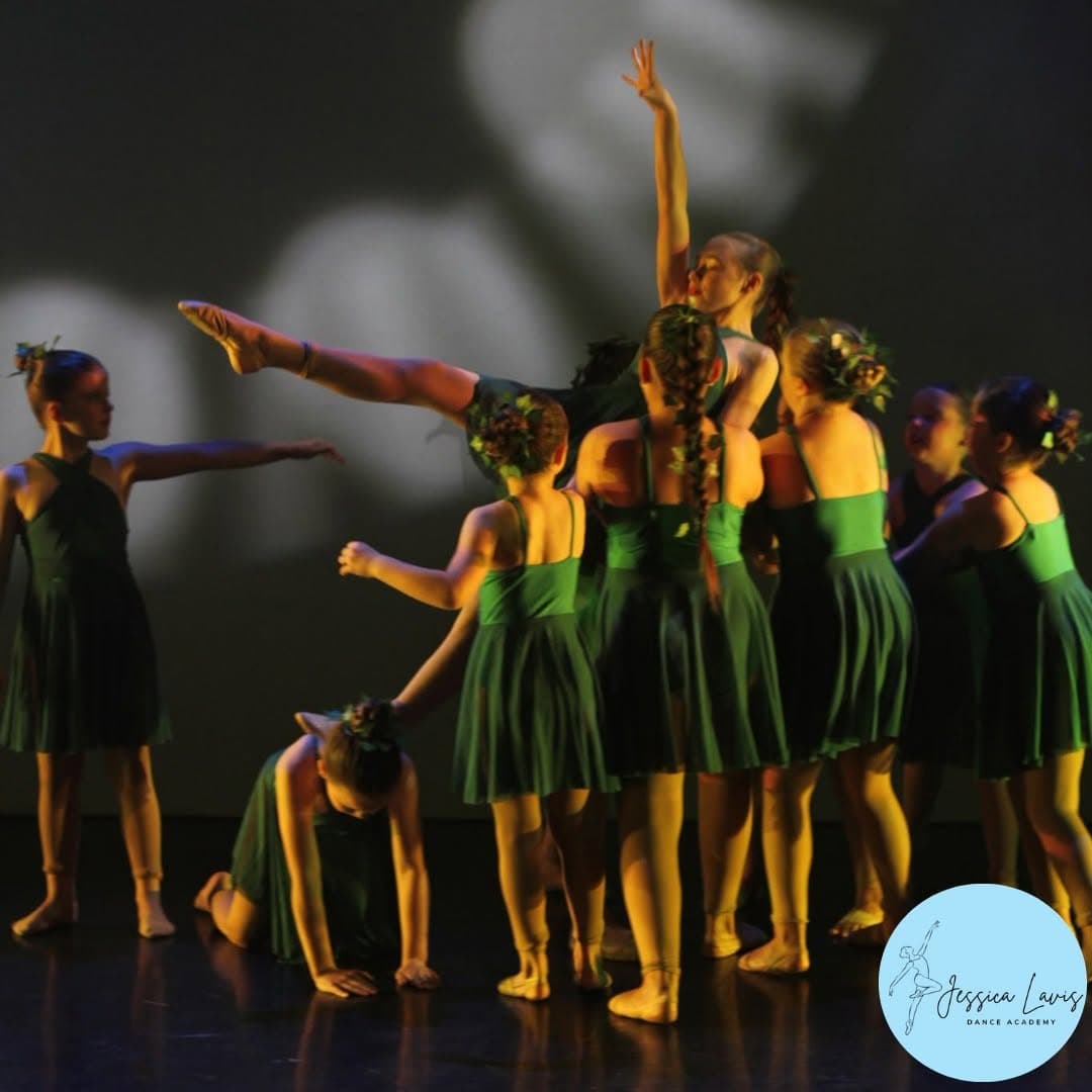 The cast lifting a dancer aloft during the woodland scene of the annual show