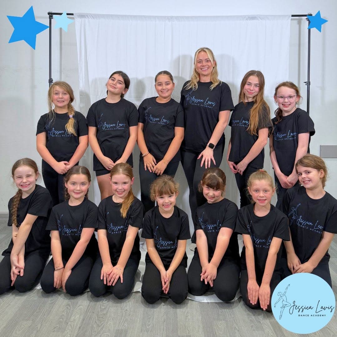 Miss Jess and the JLDA dancers in black academy t-shirts posing for a team photo